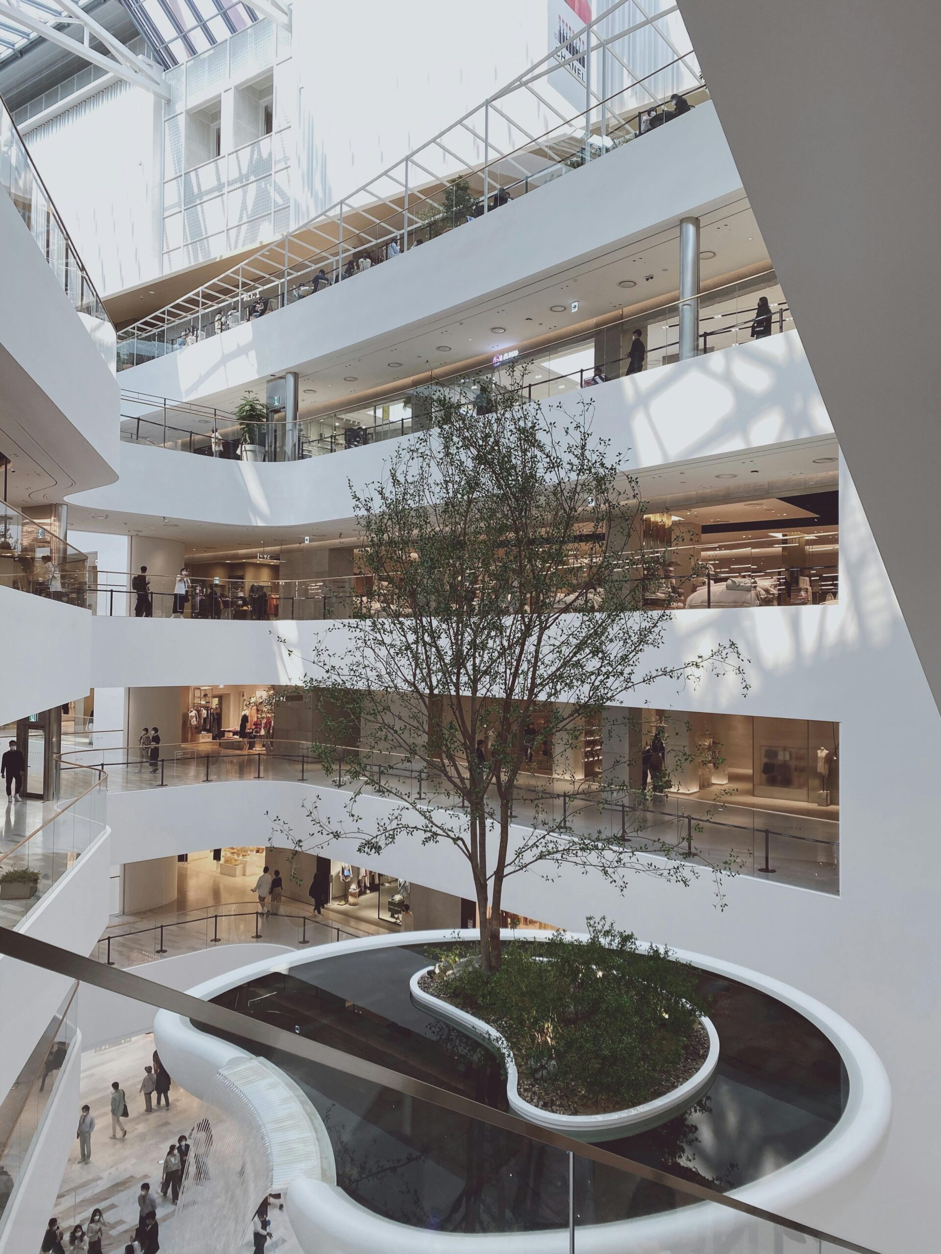 Spacious interior of a shopping mall in Seoul with modern design and natural light.